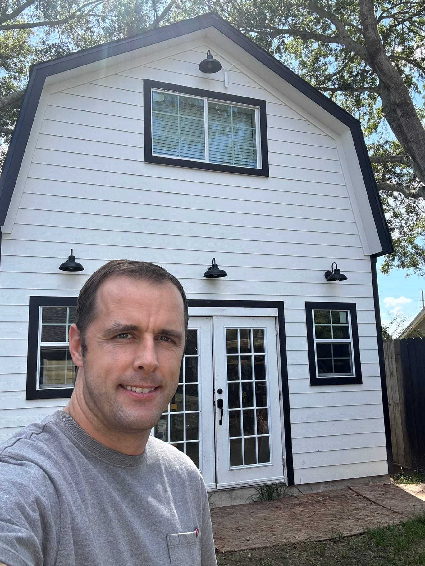 Ben Hilton in front of the woodworking barn he built in Katy, TX